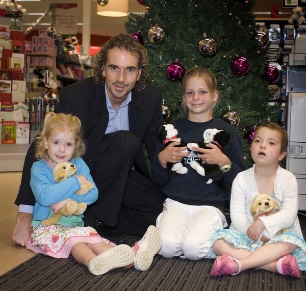Lyle Hastings, Paper Plus Group Marketing Manager, and Cure Kids ambassadors, Olivia, Alana and Laura with Boots and Butterscotch.